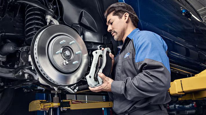 Technician replacing brake pads
