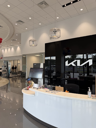 Front desk and Kia wall inside the Jenkins Kia of Cocoa showroom