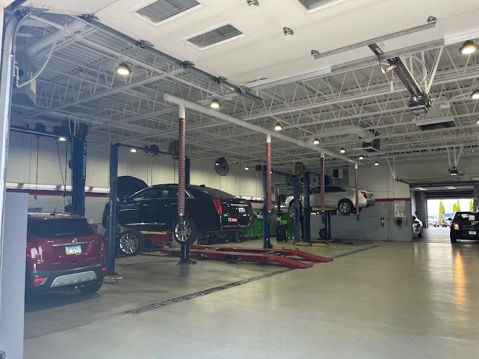 Vehicles on lifts in the Rizza Buick GMC service department