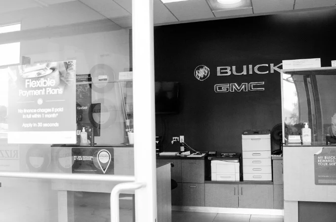 Buick and GMC logos behind the front counter at Rizza Buick GMC