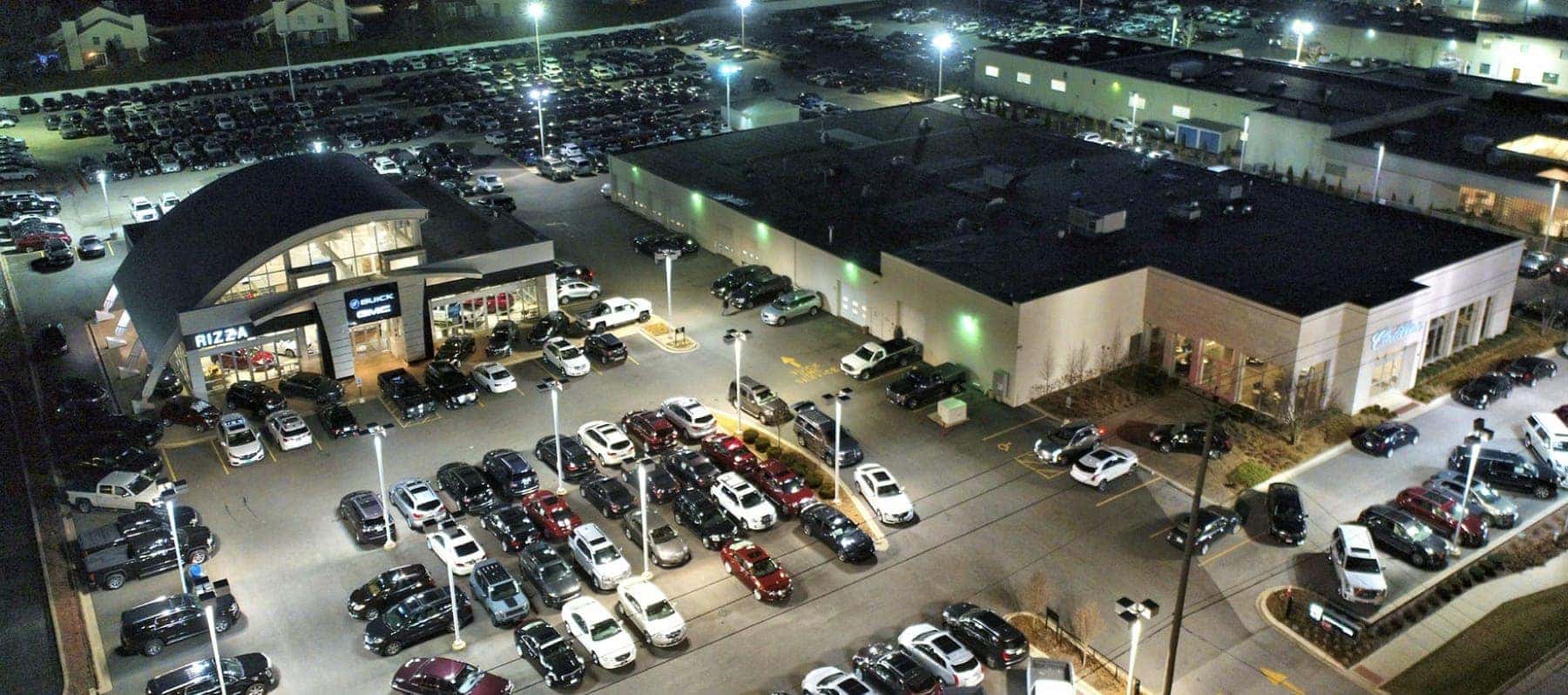 Aerial night view of the Rizza Buick GMC showroom and inventory lots in Tinley Park, IL