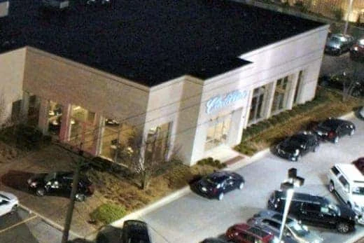Night aerial view of the Rizza Cadillac storefront and parking lot