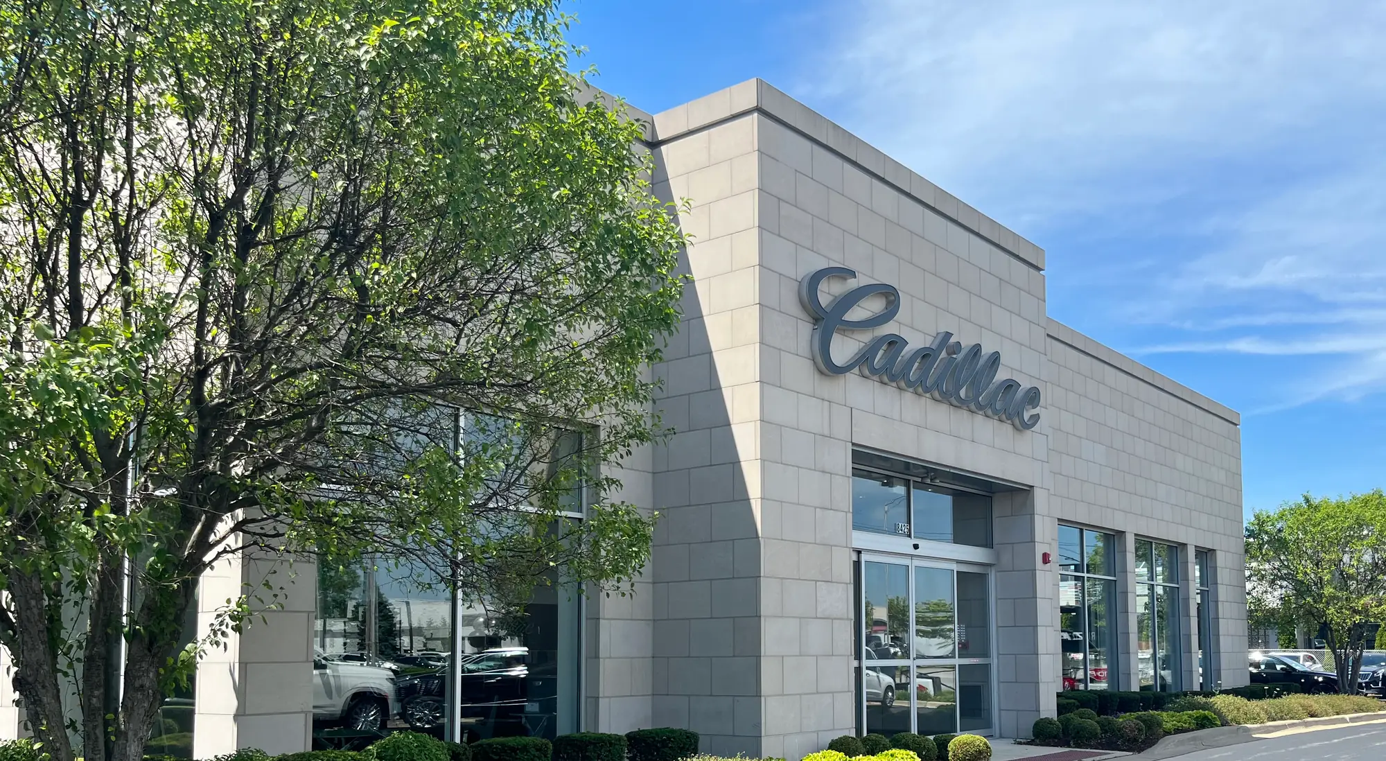 The Rizza Cadillac showroom building and its Cadillac script sign in Tinley Park, IL